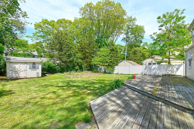 view of yard with a storage unit, an outdoor structure, and a wooden deck