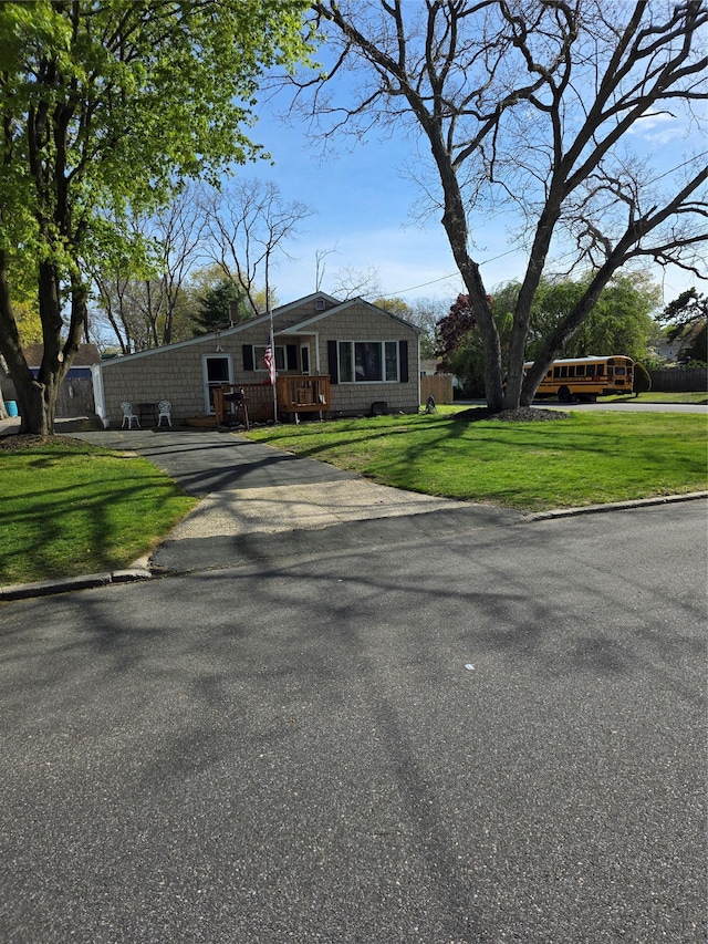 78 Brentwood St, Bay Shore, NY 11706 - view of front facade with driveway, a front lawn, and a wooden deck