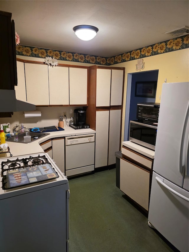 78 Brentwood St, Bay Shore, NY 11706 - kitchen with white appliances, white cabinetry, light countertops, and dark carpet