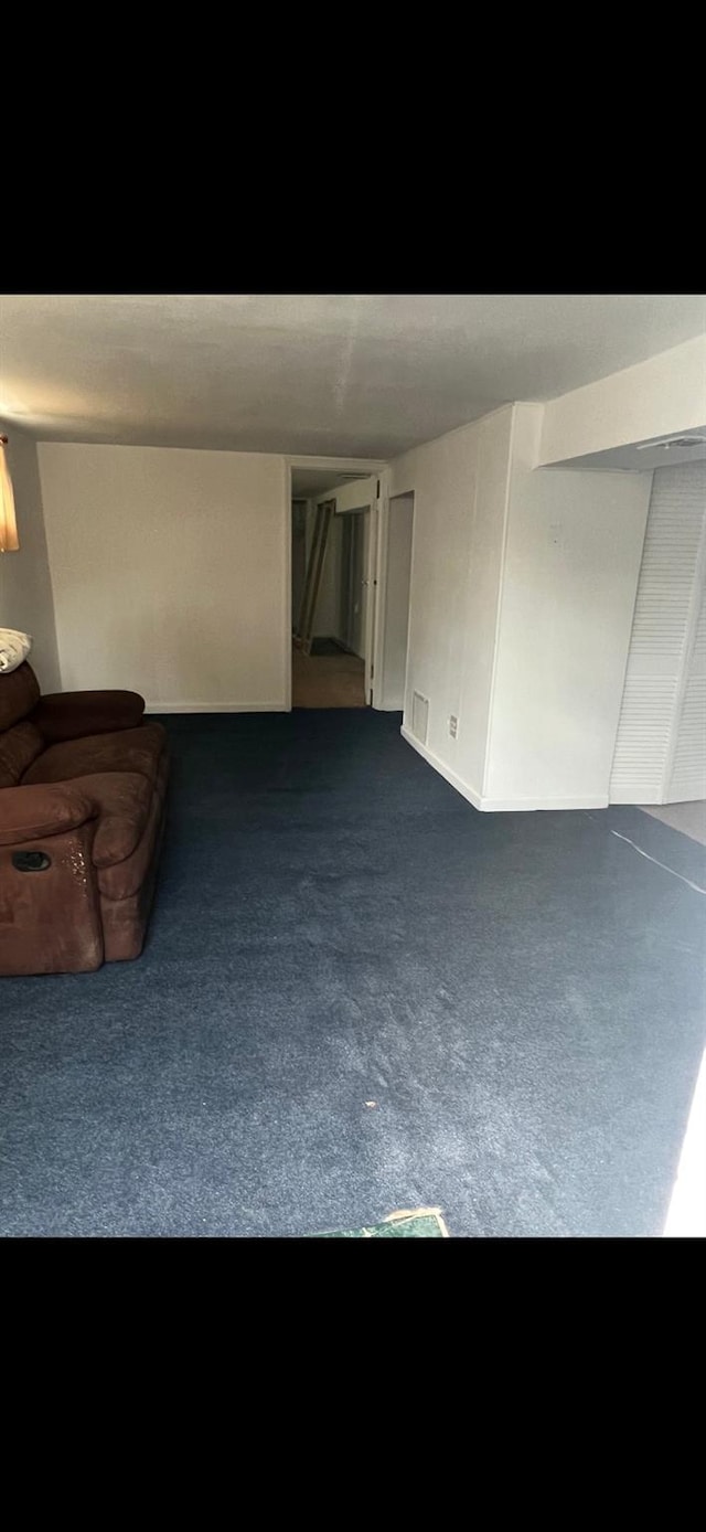 78 Brentwood St, Bay Shore, NY 11706 - living room featuring dark colored carpet