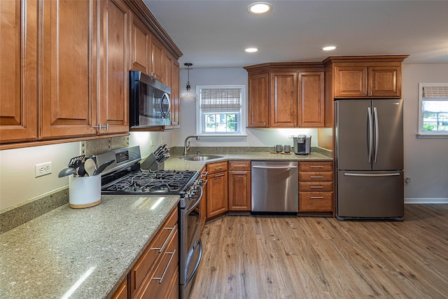 50 Louisiana Ave Unit 9R, Bronxville, NY 10708 - kitchen with appliances with stainless steel finishes, a sink, light wood-style flooring, brown cabinets, and recessed lighting