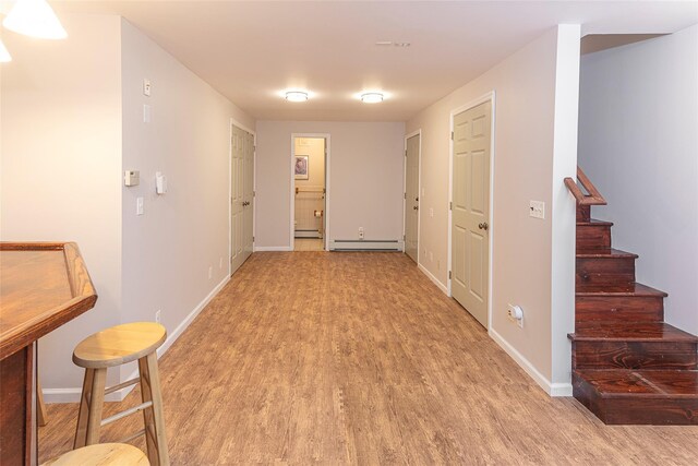 50 Louisiana Ave Unit 9R, Bronxville, NY 10708 - hall with light wood-type flooring, a baseboard heating unit, baseboards, and stairs