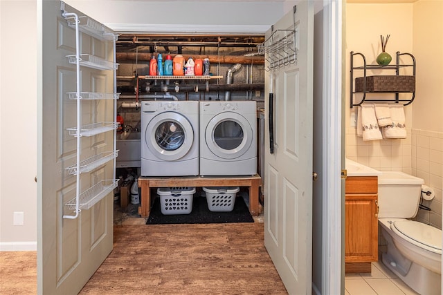 50 Louisiana Ave Unit 9R, Bronxville, NY 10708 - laundry area with washing machine and dryer, tile walls, and light wood-style flooring