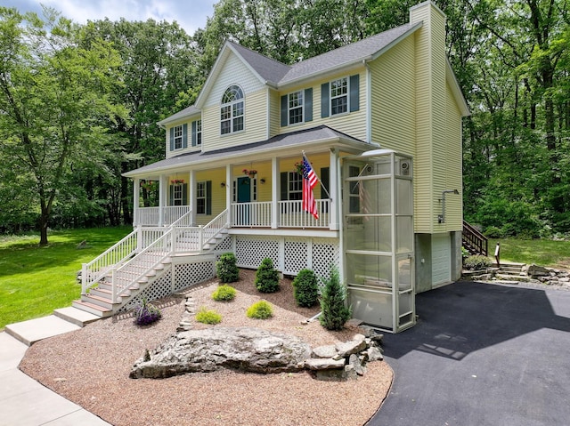 293 S Centerville Rd, Middletown, NY 10940 - view of front facade featuring stairway, a porch, a chimney, asphalt driveway, and a garage