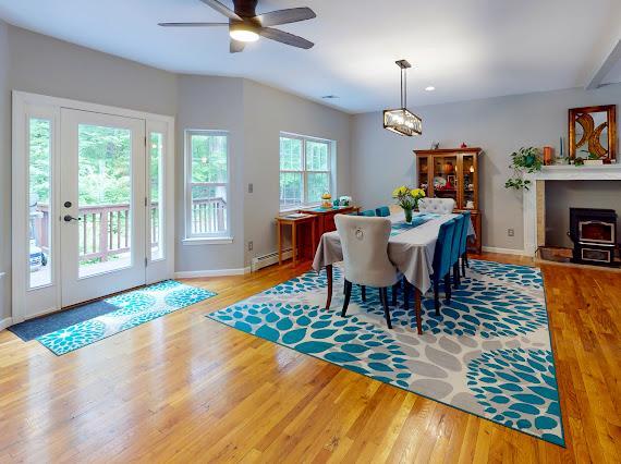 293 S Centerville Rd, Middletown, NY 10940 - dining space featuring baseboard heating, wood finished floors, baseboards, and ceiling fan