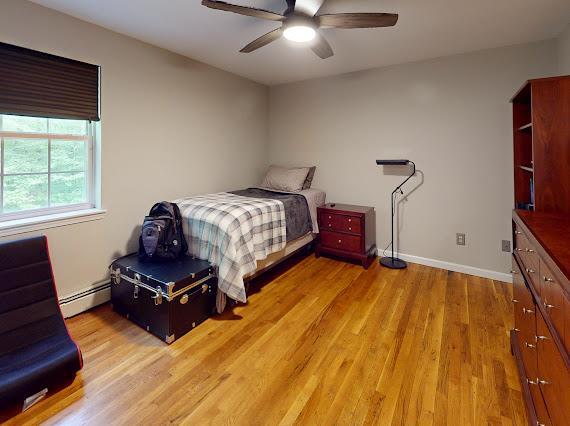 293 S Centerville Rd, Middletown, NY 10940 - bedroom with a baseboard radiator, light wood finished floors, baseboards, and ceiling fan