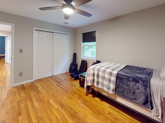 293 S Centerville Rd, Middletown, NY 10940 - bedroom featuring light wood-type flooring, a closet, baseboards, and a ceiling fan