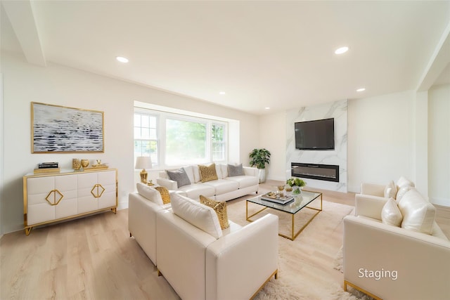 2001 Wellington Ct, Westbury, NY 11590 - living area featuring light wood-style flooring, recessed lighting, and a premium fireplace