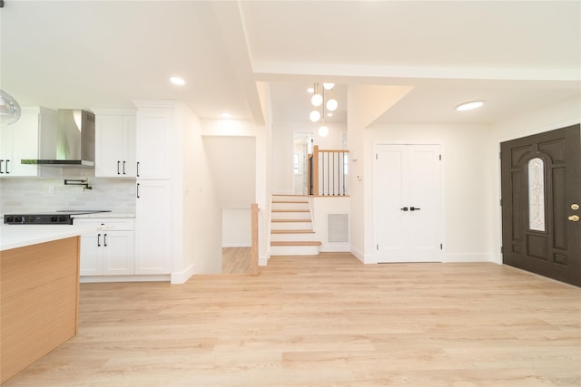 2001 Wellington Ct, Westbury, NY 11590 - entryway with stairs, light wood finished floors, baseboards, and recessed lighting