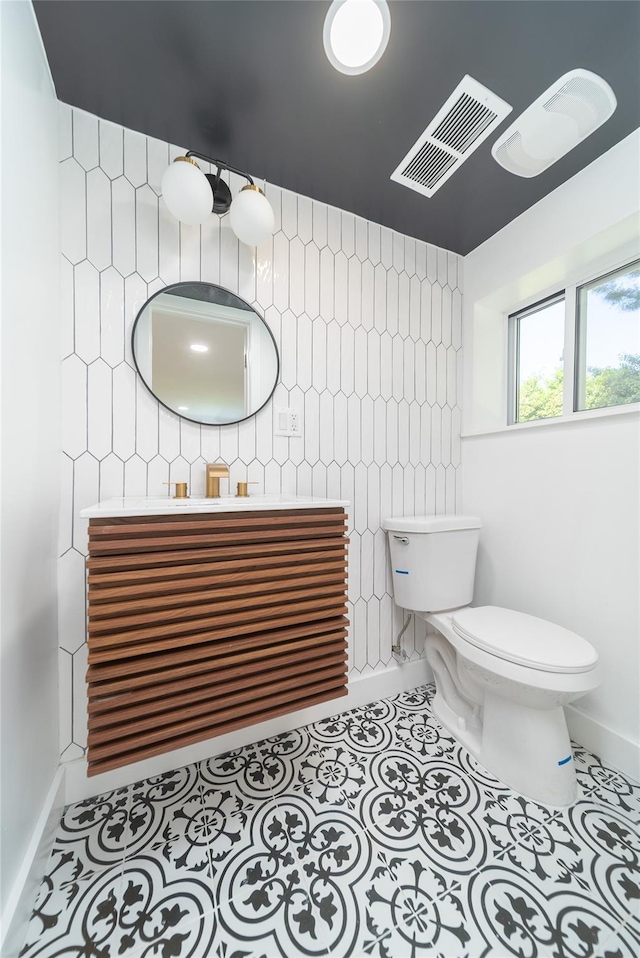 2001 Wellington Ct, Westbury, NY 11590 - bathroom with toilet, tile patterned flooring, baseboards, and vanity
