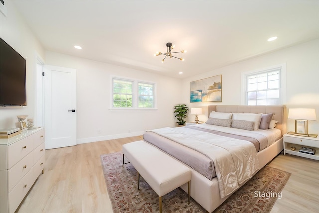 2001 Wellington Ct, Westbury, NY 11590 - bedroom with a chandelier, light wood-type flooring, recessed lighting, and baseboards