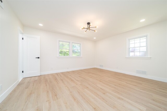 2001 Wellington Ct, Westbury, NY 11590 - unfurnished room featuring light wood-style flooring, a chandelier, recessed lighting, and baseboards