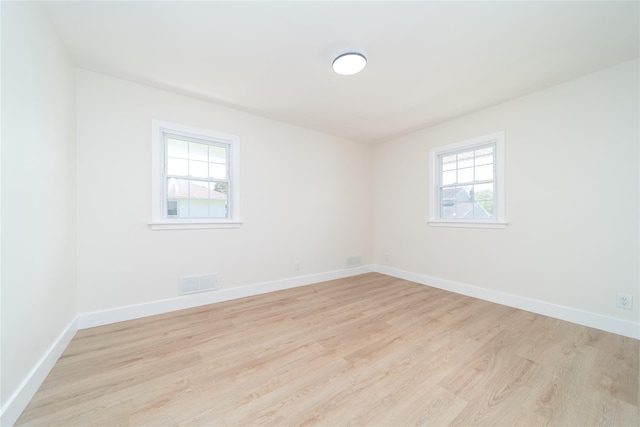 2001 Wellington Ct, Westbury, NY 11590 - unfurnished room featuring plenty of natural light, light wood finished floors, and baseboards
