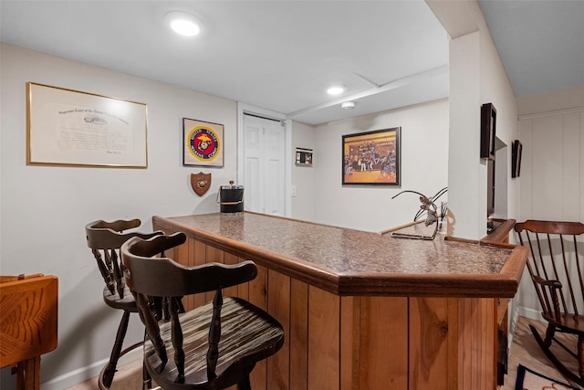 indoor dry bar featuring baseboards and recessed lighting