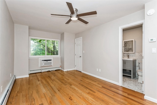 empty room with a baseboard radiator, ceiling fan, light wood-type flooring, and a wall mounted air conditioner