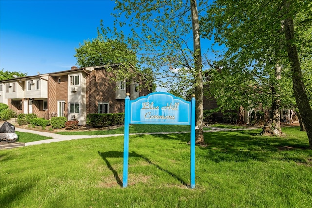 view of property's community with a lawn