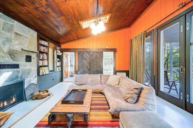 62 Stag Forest Rd, Forestburgh, NY 12777 - living area featuring healthy amount of natural light, lofted ceiling, wooden ceiling, a skylight, and a stone fireplace