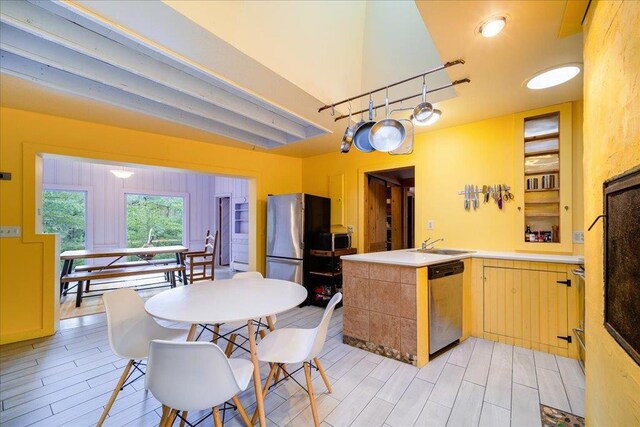 62 Stag Forest Rd, Forestburgh, NY 12777 - kitchen with appliances with stainless steel finishes, a sink, a peninsula, and light wood-type flooring