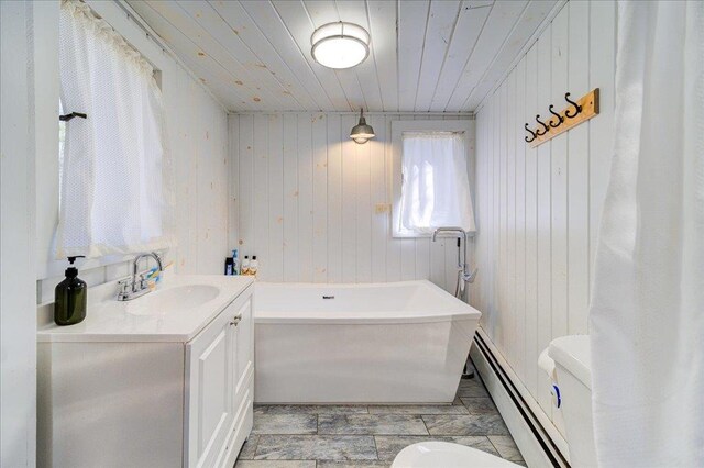 62 Stag Forest Rd, Forestburgh, NY 12777 - bathroom with toilet, baseboard heating, a bathtub, wood finished floors, and wood ceiling