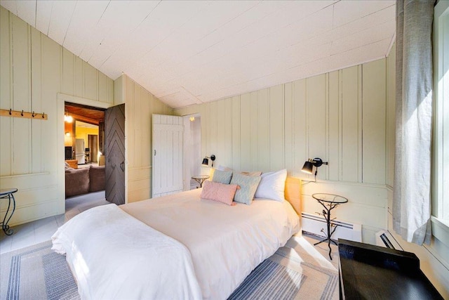 62 Stag Forest Rd, Forestburgh, NY 12777 - bedroom featuring lofted ceiling, baseboard heating, and a decorative wall