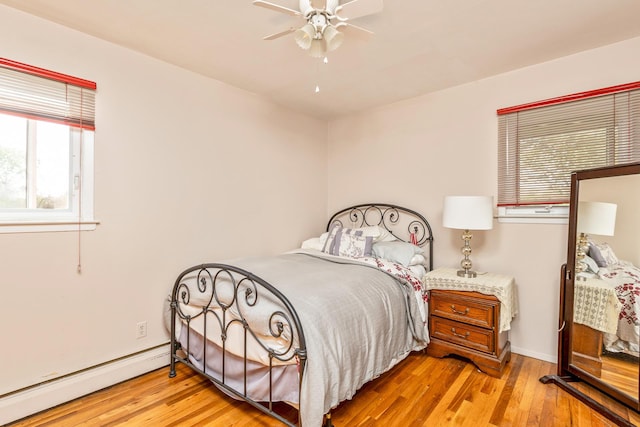 284 Bow Dr, Hauppauge, NY 11788 - bedroom featuring a baseboard radiator, wood finished floors, and a ceiling fan