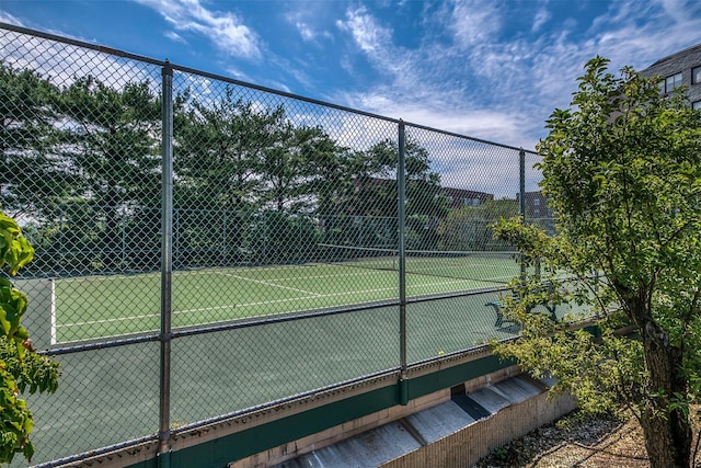 view of tennis court featuring fence
