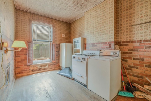 62-12 60th Dr, Maspeth, NY 11378 - kitchen featuring white appliances, washer / dryer, hardwood / wood-style floors, wallpapered walls, and an ornate ceiling