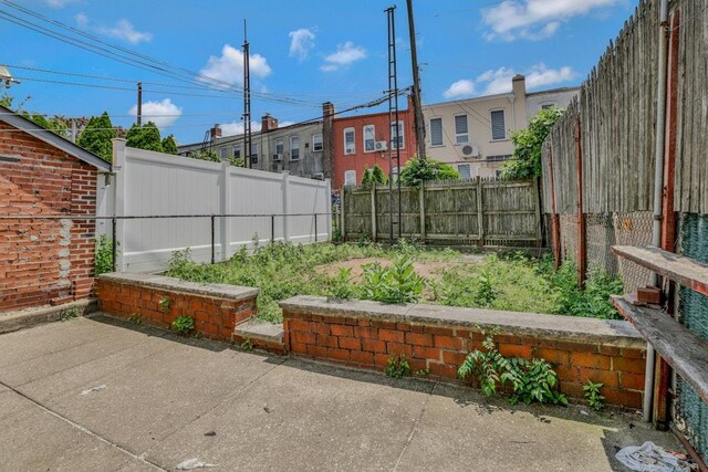 62-12 60th Dr, Maspeth, NY 11378 - fenced backyard with a patio