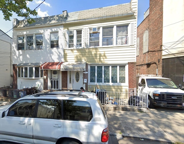 townhome / multi-family property featuring brick siding