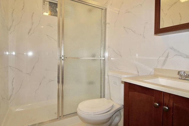 full bath with a stall shower, toilet, and vanity