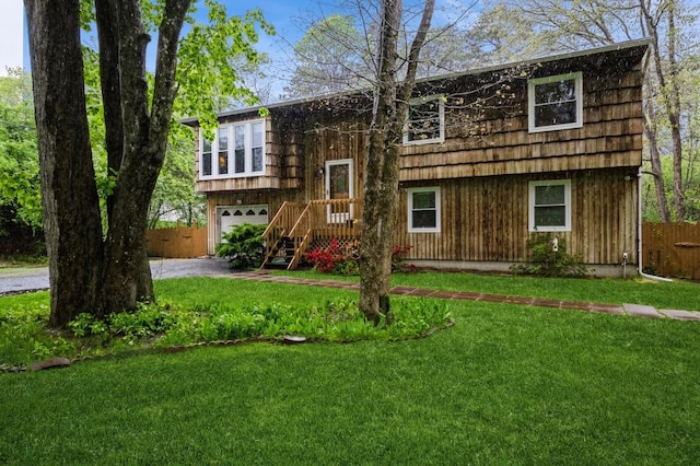bi-level home with a garage and driveway