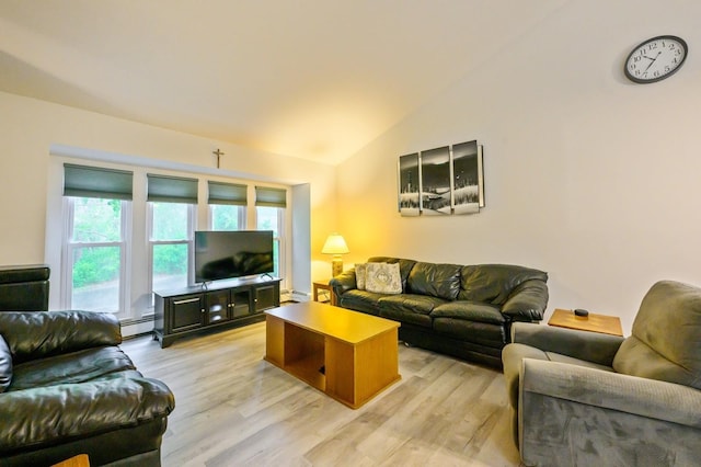 living room with a baseboard heating unit, lofted ceiling, and light wood-style flooring