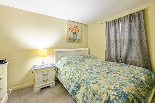 bedroom featuring carpet and baseboards