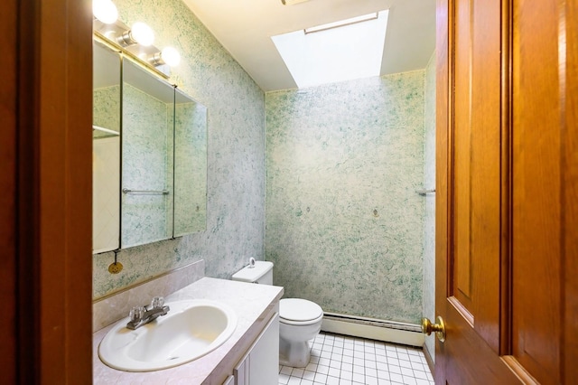 bathroom with baseboard heating, wallpapered walls, a skylight, tile patterned floors, and toilet