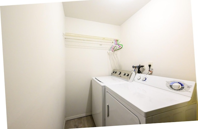 washroom featuring independent washer and dryer, wood finished floors, and baseboards