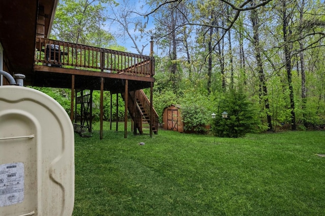 view of green lawn featuring stairway, a shed, a wooden deck, an outbuilding, and heating fuel