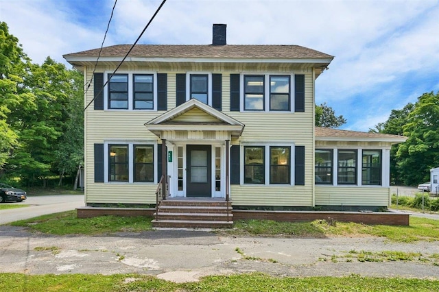 541 Broadway, Monticello, NY 12701 - view of front of home with a chimney, entry steps, and roof with shingles