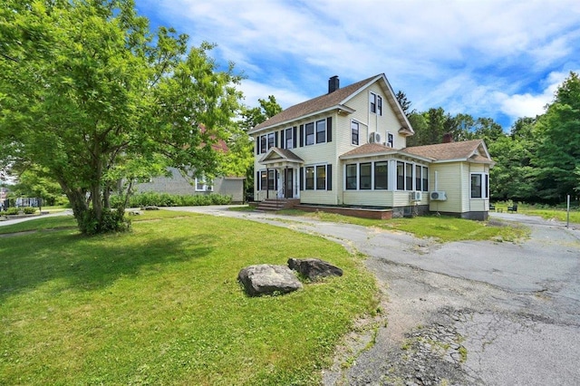 541 Broadway, Monticello, NY 12701 - view of front of home with a chimney and a front lawn