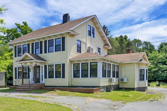 541 Broadway, Monticello, NY 12701 - view of front of home featuring a chimney, a shingled roof, and a cooling unit
