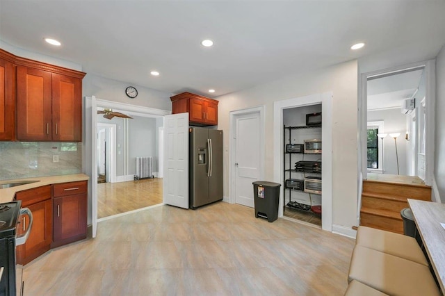 541 Broadway, Monticello, NY 12701 - kitchen with appliances with stainless steel finishes, radiator heating unit, light countertops, recessed lighting, and tasteful backsplash