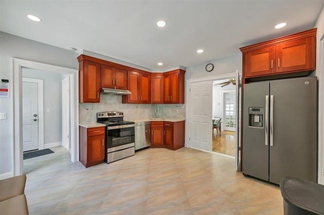 541 Broadway, Monticello, NY 12701 - kitchen featuring stainless steel appliances, light countertops, a ceiling fan, tasteful backsplash, and under cabinet range hood
