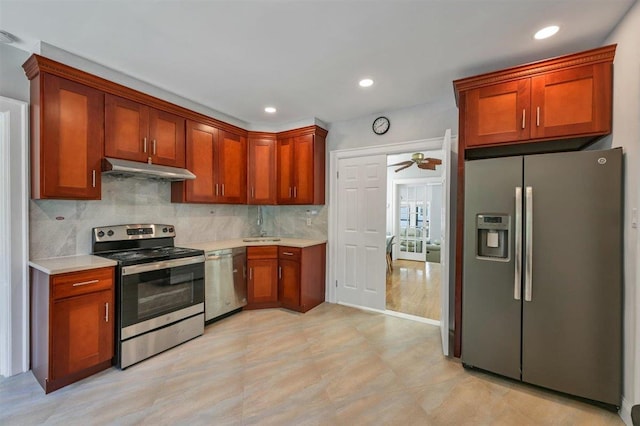 541 Broadway, Monticello, NY 12701 - kitchen with stainless steel appliances, under cabinet range hood, light countertops, decorative backsplash, and ceiling fan