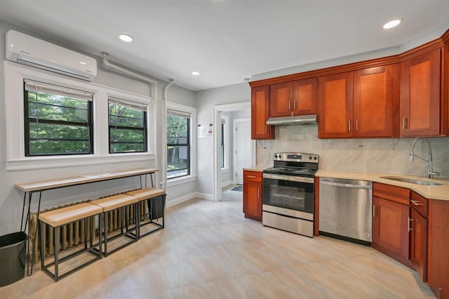 541 Broadway, Monticello, NY 12701 - kitchen featuring appliances with stainless steel finishes, a sink, a wall mounted air conditioner, under cabinet range hood, and healthy amount of natural light