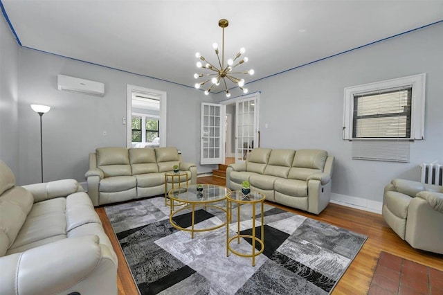 541 Broadway, Monticello, NY 12701 - living area featuring a wall mounted air conditioner, radiator heating unit, a chandelier, wood finished floors, and baseboards
