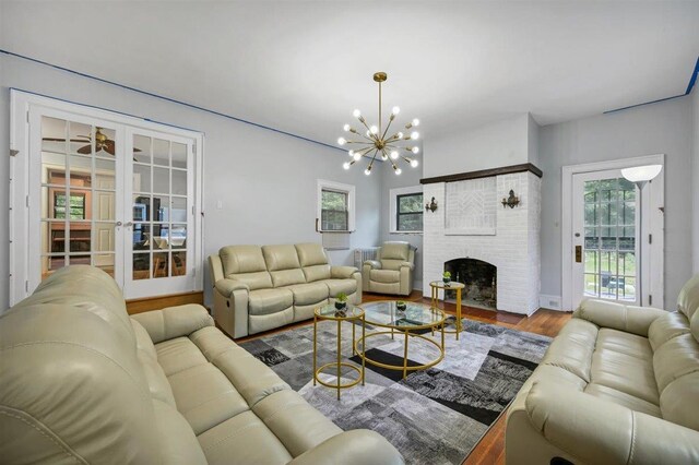 541 Broadway, Monticello, NY 12701 - living area featuring a chandelier, a fireplace, and wood finished floors