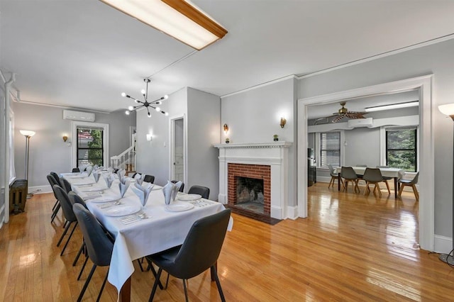 541 Broadway, Monticello, NY 12701 - dining space with a wall mounted air conditioner, light wood-style floors, healthy amount of natural light, and a chandelier