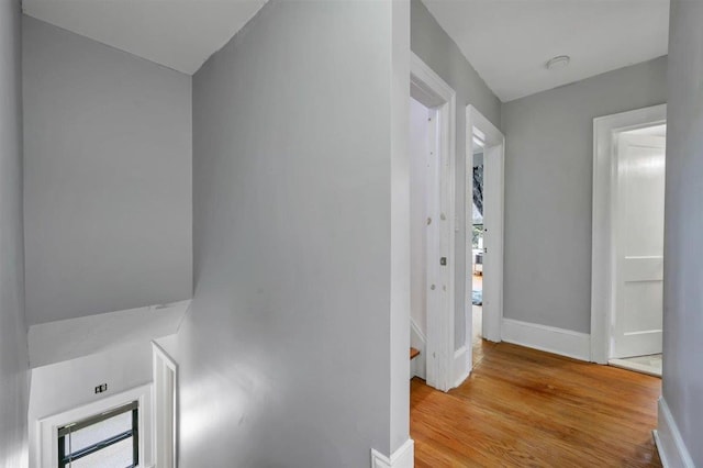 541 Broadway, Monticello, NY 12701 - corridor with light wood-style floors, baseboards, and an upstairs landing