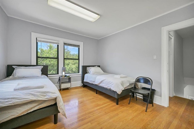 541 Broadway, Monticello, NY 12701 - bedroom featuring light wood-style flooring, crown molding, and baseboards