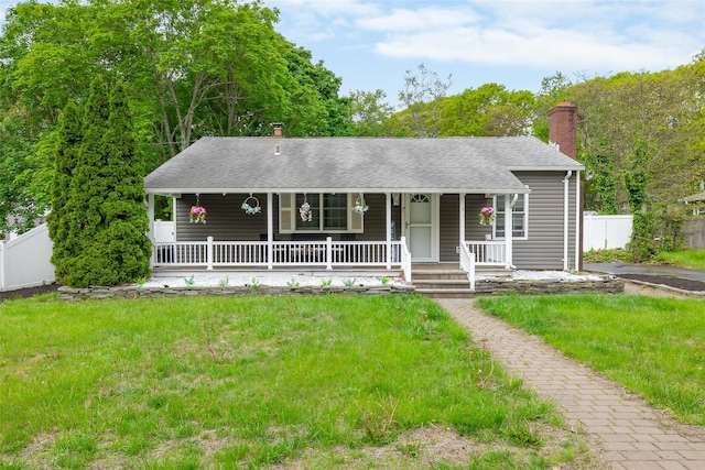 52 Robinwood St, Mastic, NY 11950 - view of front facade featuring a chimney, a porch, and a shingled roof