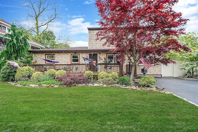 2 Burnett Ave, Bay Shore, NY 11706 - view of front of home with asphalt driveway, stone siding, a wooden deck, and a front lawn